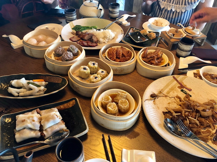 A table full of lunchtime dim sum dishes